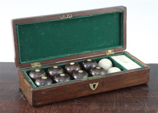 A mahogany cased set of indoor carpet bowls, 9.75in.